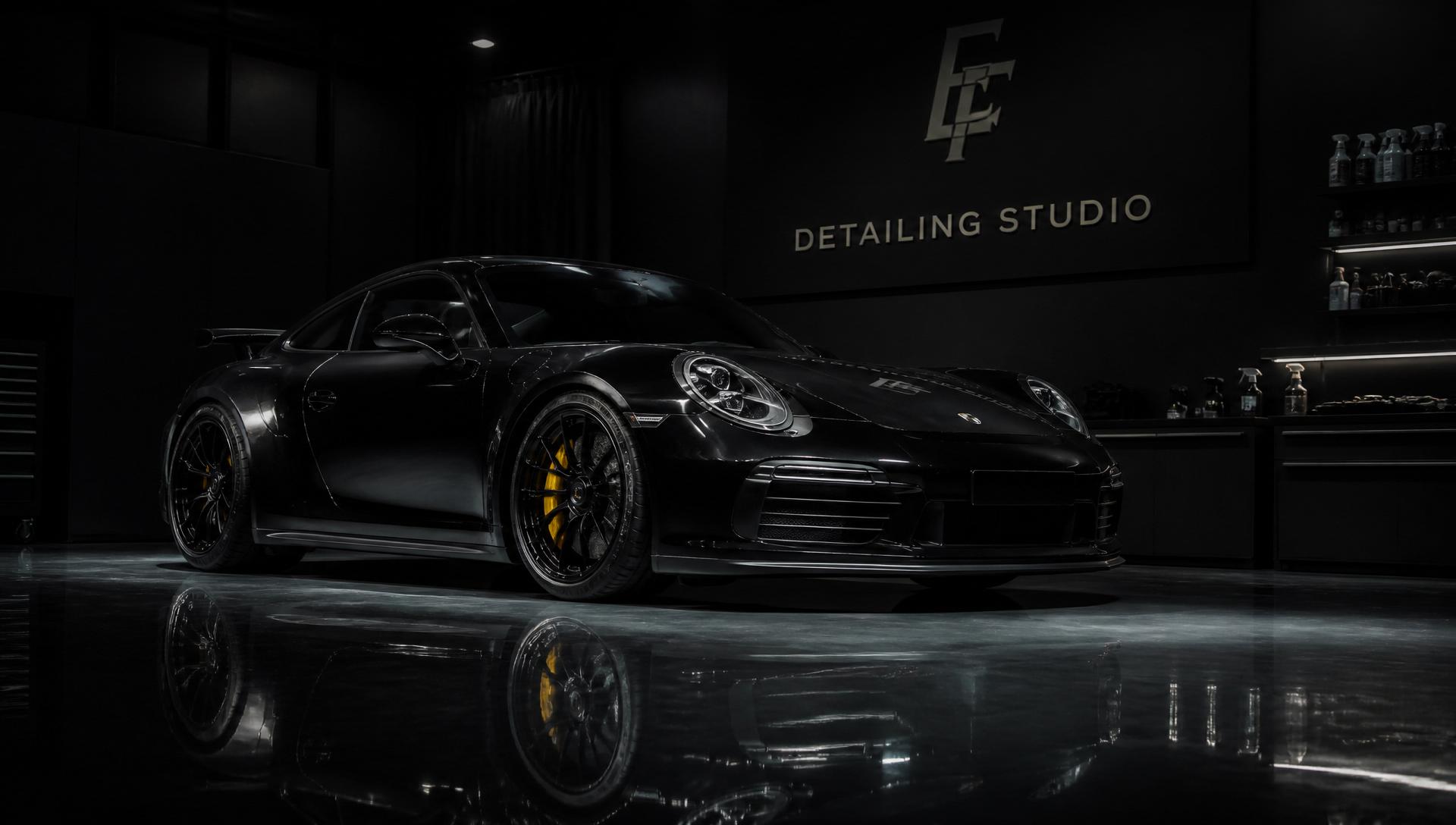 Luxury black sports car inside Eclipse detailing studio